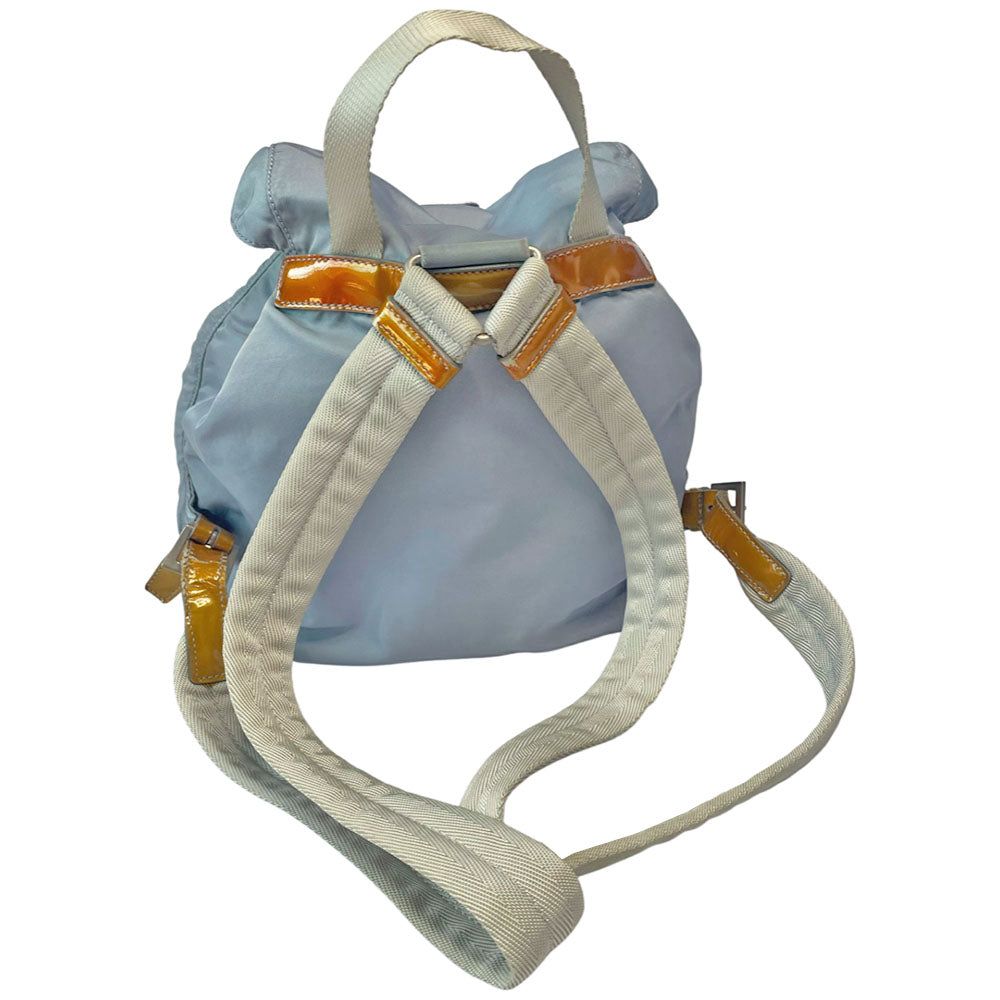 Prada powder blue nylon tessuto drawstring backpack circa 2011, magnetic closure flap with Prada logo plate, 2 zip outer front pockets, brown patent leather strap & accent, silver-tone Prada engraved buckle & drawstring grommets. Adjustable webbing & leather straps. Beige jacquard Prada logo textile lining with interior zip pocket. Made in Italy