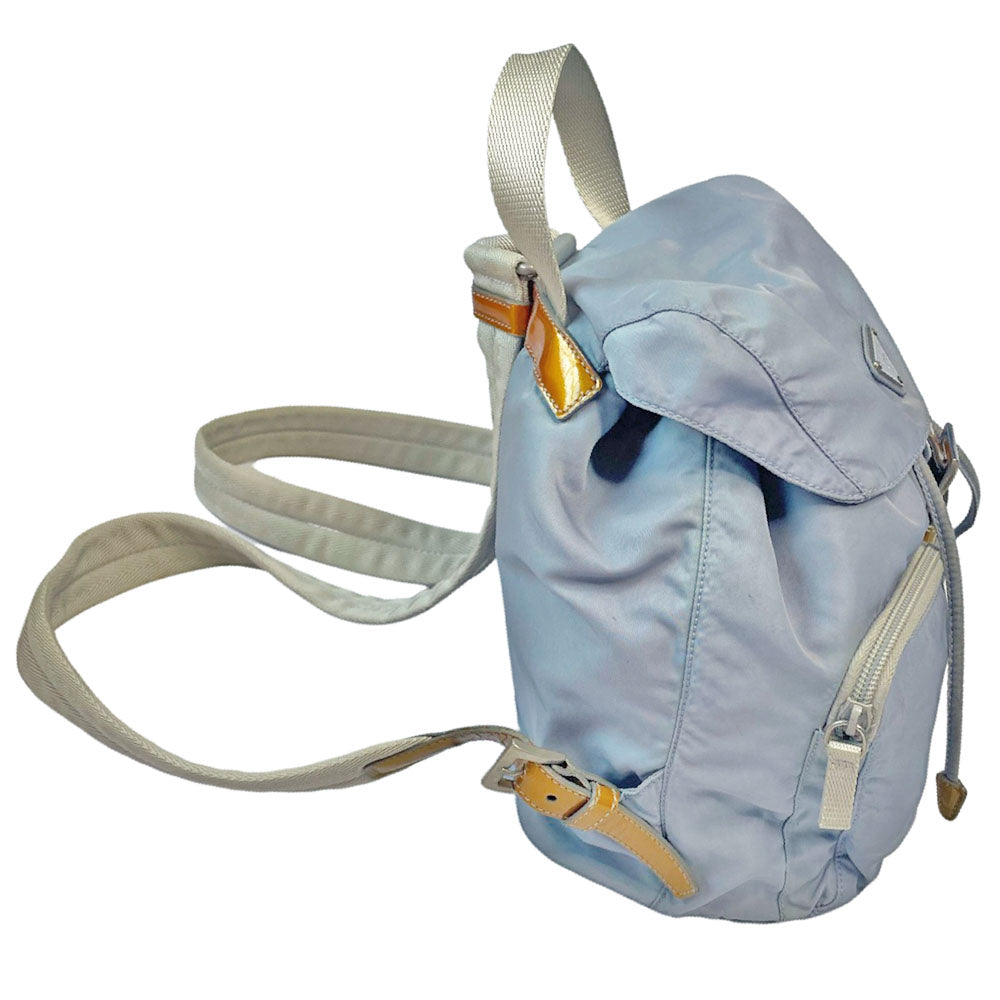 Prada powder blue nylon tessuto drawstring backpack circa 2011, magnetic closure flap with Prada logo plate, 2 zip outer front pockets, brown patent leather strap & accent, silver-tone Prada engraved buckle & drawstring grommets. Adjustable webbing & leather straps. Beige jacquard Prada logo textile lining with interior zip pocket. Made in Italy