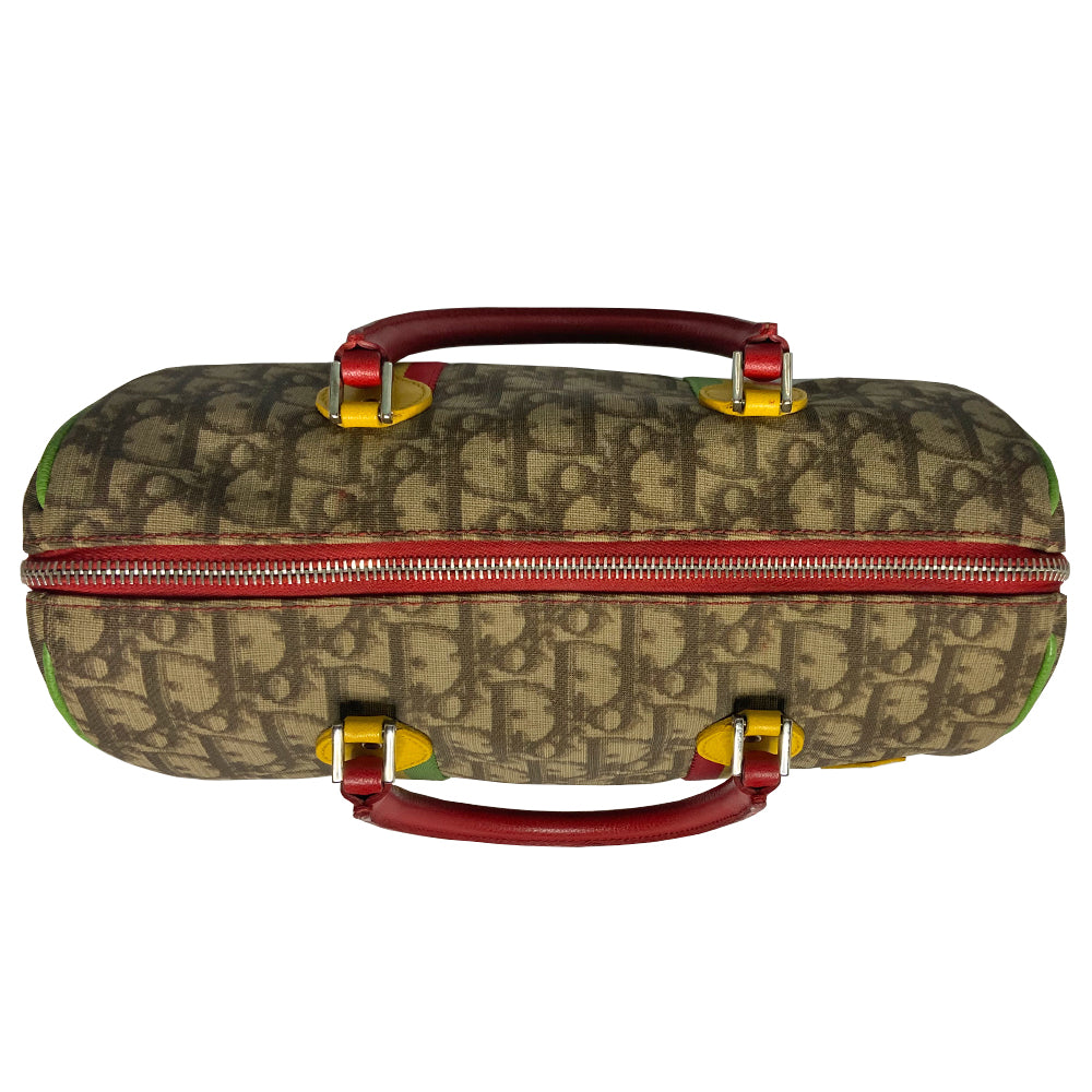 Christian Dior Rasta boston bag by John Galliano for Dior, 2004. Beige and light brown Diorissimo coated canvas with silver-tone hardware, 2 vermillion colored leather rolled top handles, yellow accent leather at base of handles. Yellow leather No 1 in front with red, yellow and green canvas stripe, green piping. Vermillion textile lining with zip pocket, top zip closure. Made in Italy