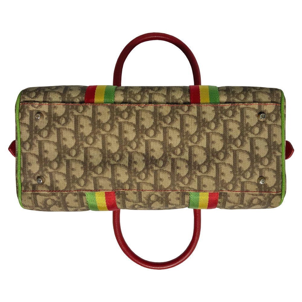 Christian Dior Rasta boston bag by John Galliano for Dior, 2004. Beige and light brown Diorissimo coated canvas with silver-tone hardware, 2 vermillion colored leather rolled top handles, yellow accent leather at base of handles. Yellow leather No 1 in front with red, yellow and green canvas stripe, green piping. Vermillion textile lining with zip pocket, top zip closure. Made in Italy