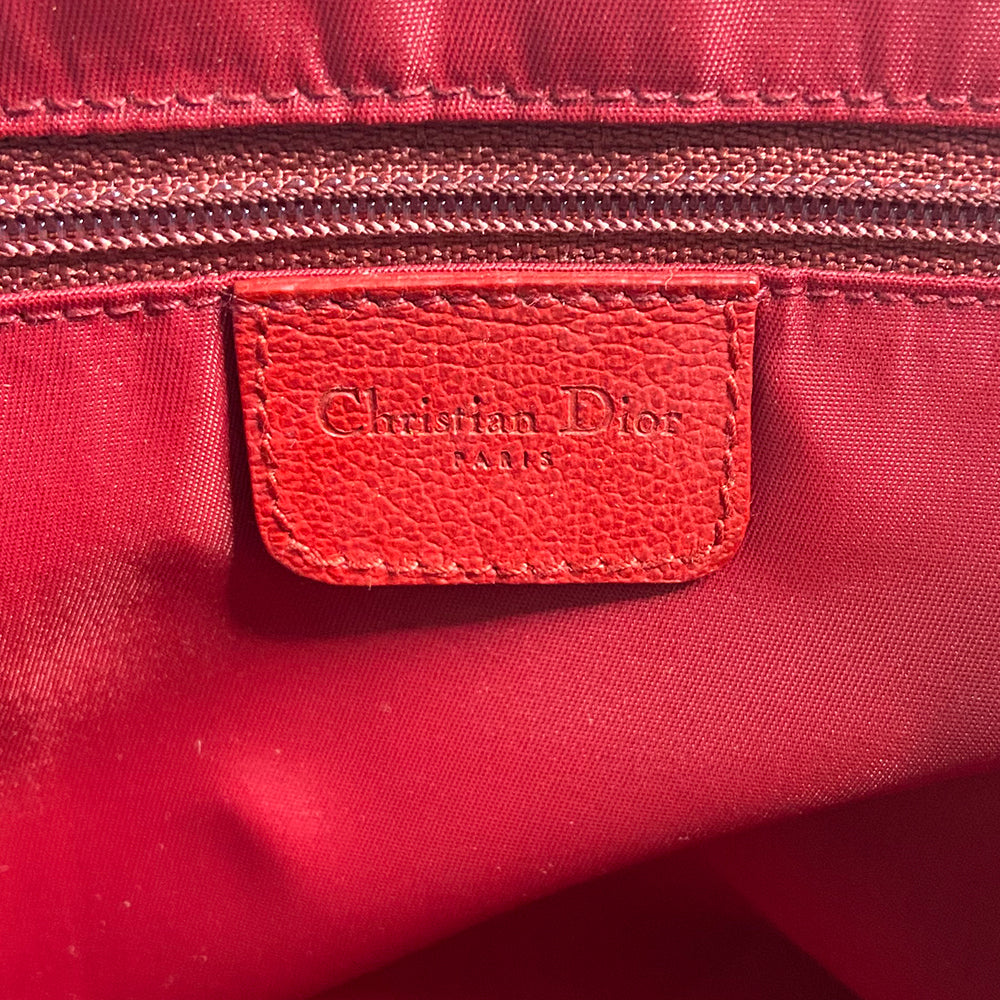 Christian Dior Rasta boston bag by John Galliano for Dior, 2004. Beige and light brown Diorissimo coated canvas with silver-tone hardware, 2 vermillion colored leather rolled top handles, yellow accent leather at base of handles. Yellow leather No 1 in front with red, yellow and green canvas stripe, green piping. Vermillion textile lining with zip pocket, top zip closure. Made in Italy