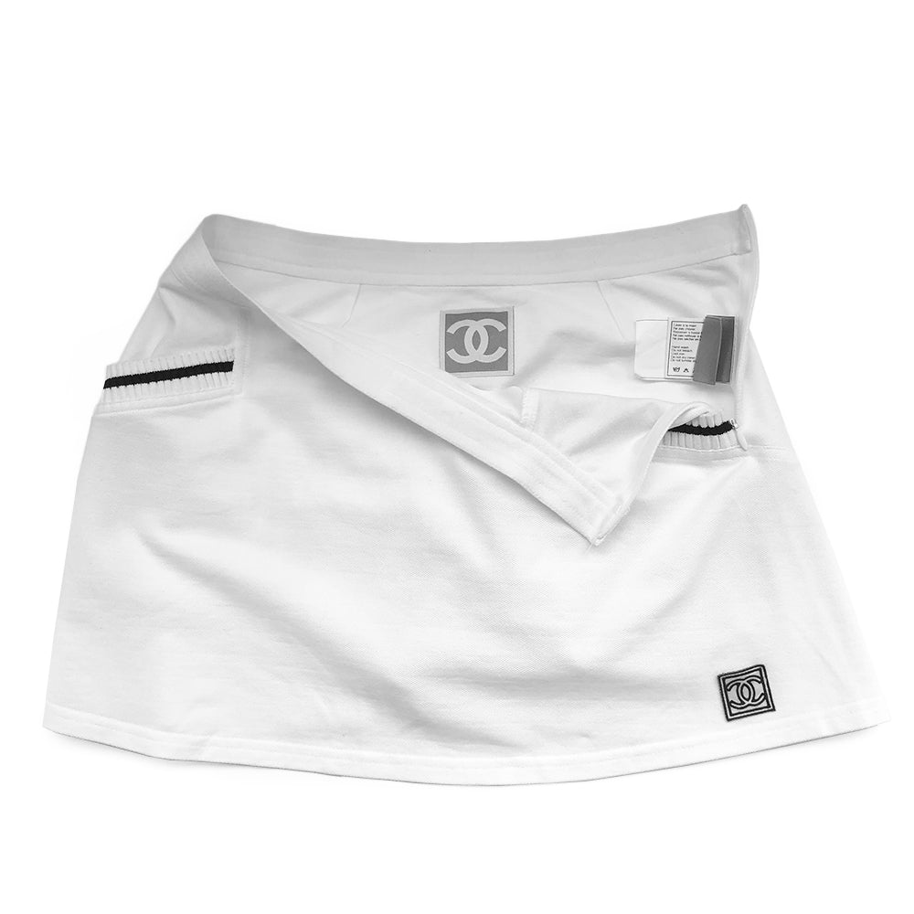 Chanel white tennis skirt, black accents on rib knit front pockets, pique polo fabric, front CC logo