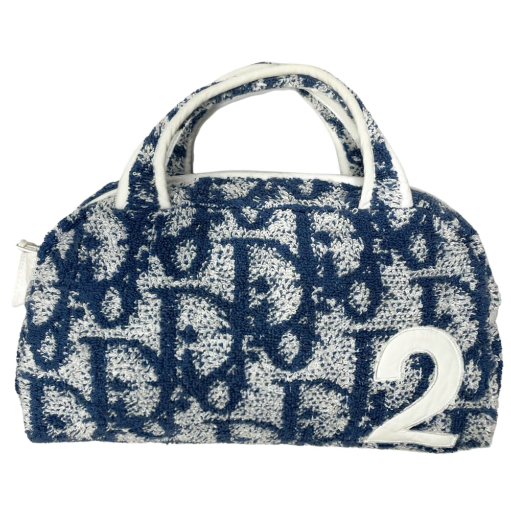 Christian Dior navy monogram terry towel mini boston bag circa 2005 with No. 2 white appliqué in front, white piping on handles and zipper. Waterproof vinyl interior with 2 slip pockets Zipper closure with white textile ribbon zipper pull.