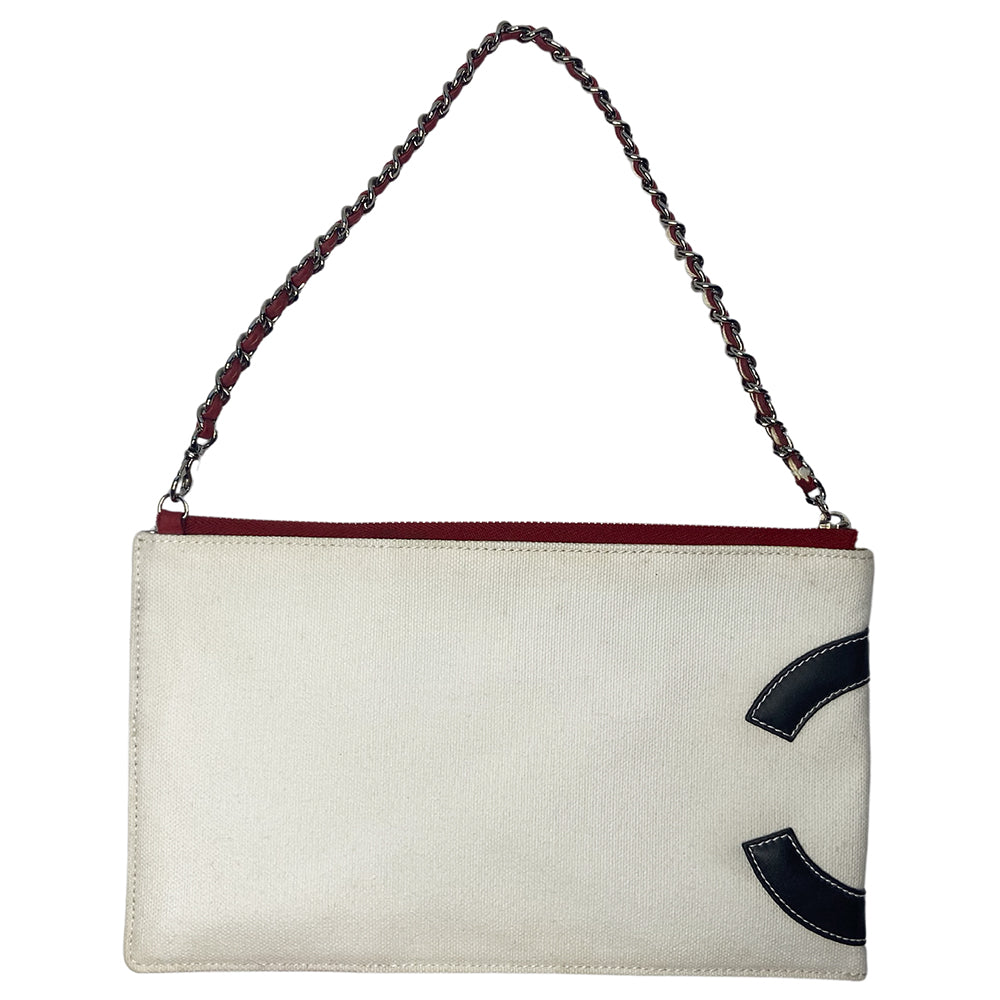 Chanel American Flag canvas and lamb leather pochette by Karl Lagerfeld for Chanel 2002/2003 with navy leather CC applique on white canvas, red leather stripes on quilted silver leather, canvas in back. Silver-tone hardware with woven leather and chain strap also acts as a zipper pull for top zip closure. Metallic silver foil vinyl lining. Made in Italy