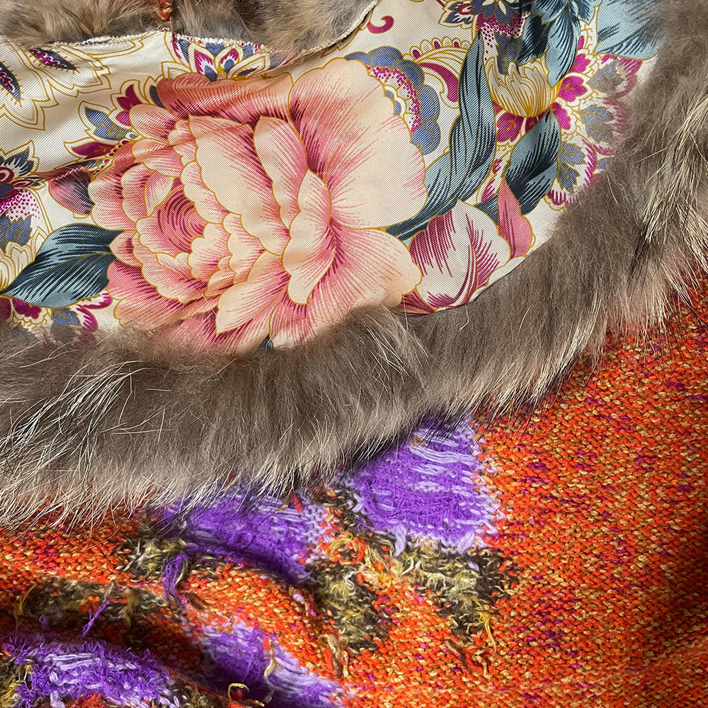 Circa 1990's from cult London label, Voyage. Orange knit body with purple and green rosebud woven print, lacing details at bell sleeves, front snap closure. Fully detachable silk lined fox fur collar.