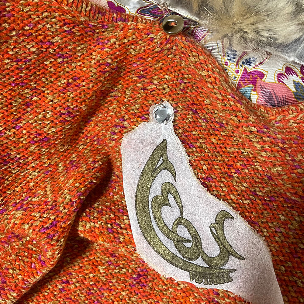 Circa 1990's from cult London label, Voyage. Orange knit body with purple and green rosebud woven print, lacing details at bell sleeves, front snap closure. Fully detachable silk lined fox fur collar.