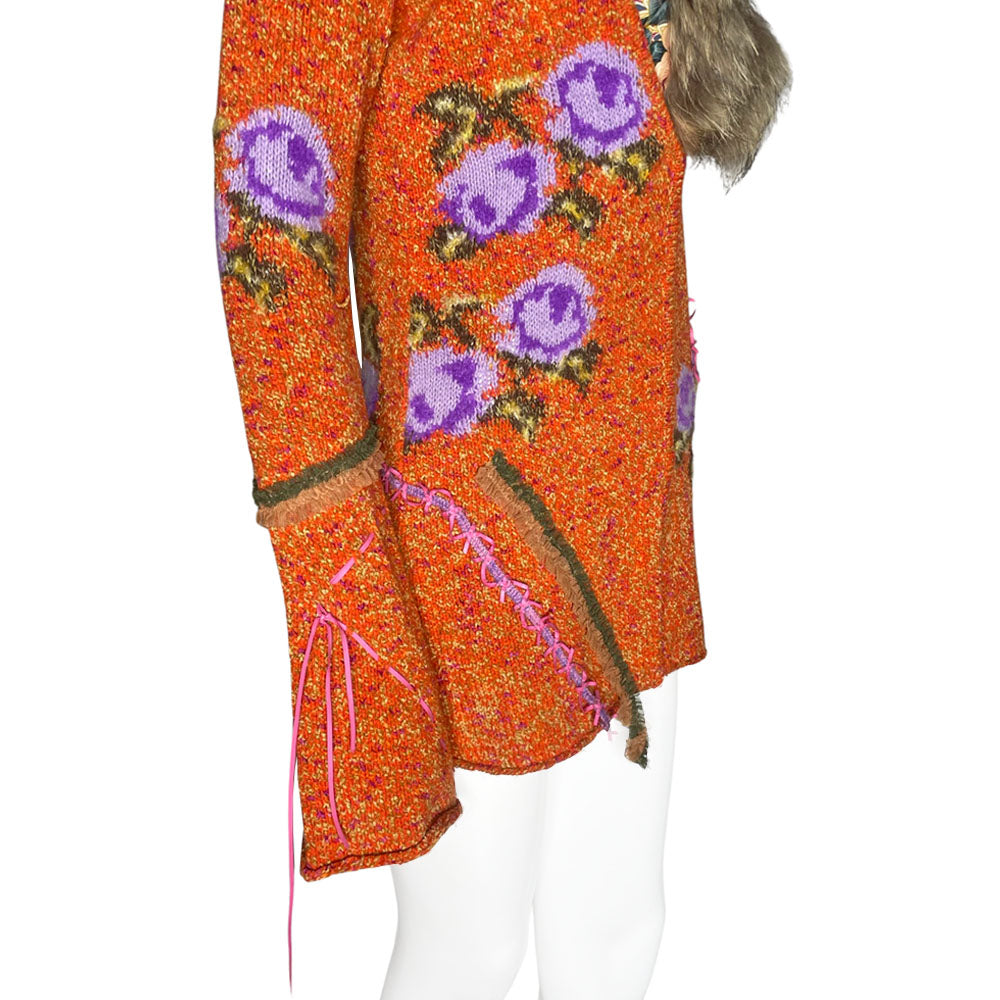 Circa 1990's from cult London label, Voyage. Orange knit body with purple and green rosebud woven print, lacing details at bell sleeves, front snap closure. Fully detachable silk lined fox fur collar.