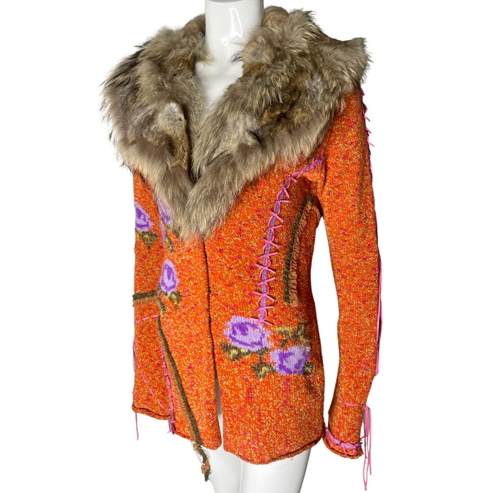 Circa 1990's from cult London label, Voyage. Orange knit body with purple and green rosebud woven print, lacing details at bell sleeves, front snap closure. Fully detachable silk lined fox fur collar.