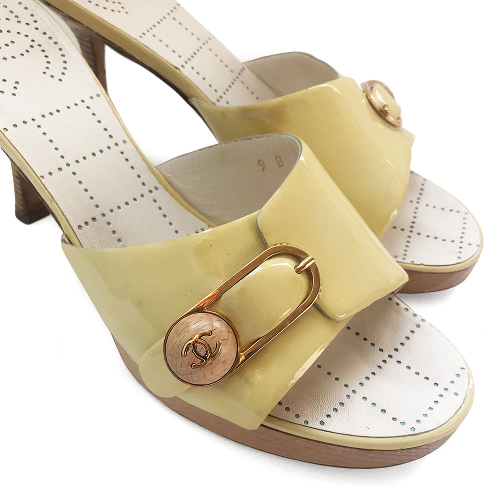 Chanel pale yellow slip on heels, patent leather upper and edges with gold-tone buckle and interlocking CC on wood button detail