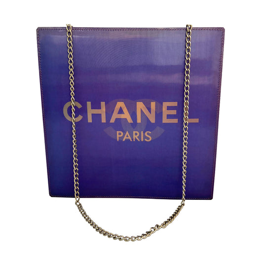 Chanel shoulder bag by Karl Lagerfeld for Chanel 2000. Rectangular vinyl bag with silver-tone double chain shoulder strap and lenticular/holograph design that flip flops between gold-tone interlocking CC logo and CHANEL Paris. Open top, vinyl interior, one zippered pocket. Made in France 