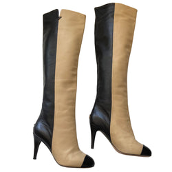 Chanel two-tone knee high lamb leather boots from Autumn 2008 by Karl Lagerfeld for Chanel. High heeled black/tan half and half slip-on to the knee heeled boots with black toe cap, gold-tone interlocking CC logo at back heels. Leather interior and soles. Size: IT 35 C. Made in Italy 