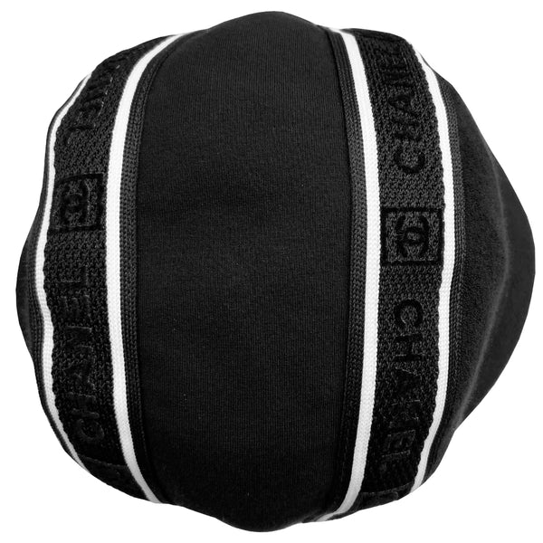 Chanel Logo Bucket Hat  From 2002 sport collection Terry cloth side panels with jersey center panel rounded bucket hat embellished with 2 black and white edged mesh bands dividing the panels Chanel and boxed CC logos printed in velvet on mesh bands Color: black with white  Size: M Fabric: Terry cloth, jersey, cotton interior  Made in France  Interior circumference (in)	22" Brim (in)	2.5"