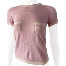 Chanel short sleeve pastel pink cashmere sweater Karl Lagerfeld for Chanel, 2004 with white accent and trim Interlocking CC logo at center chest and 2 front “faux” pockets. Size: FR 38 Made in Italy 