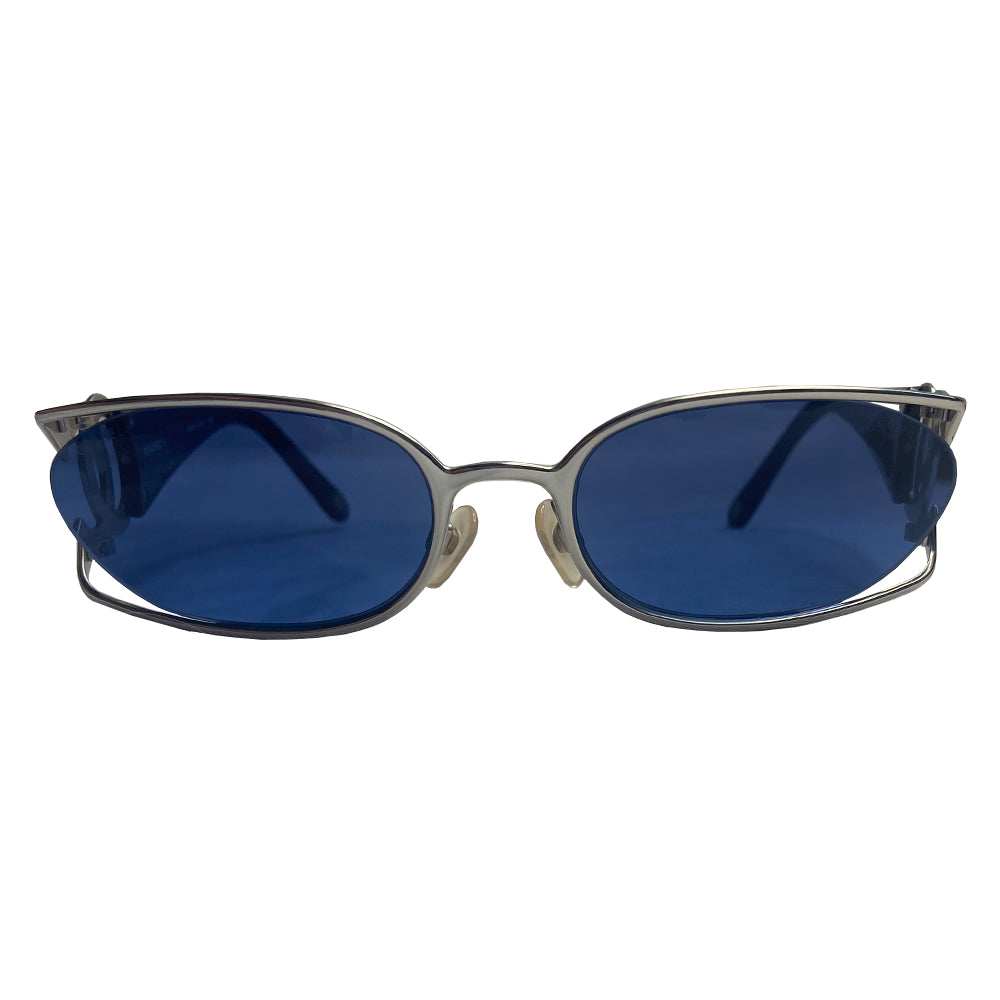 Chanel oval floating blue lens sunglasses by Karl Lagerfeld for Chanel with brushed silver-tone metal frame and cutout side CC logos at temples, thick navy acetate arms Style: 4023 c.135. Made in Italy 