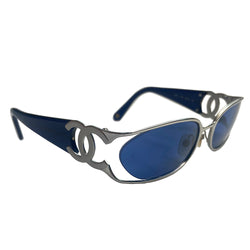Chanel oval floating blue lens sunglasses by Karl Lagerfeld for Chanel with brushed silver-tone metal frame and cutout side CC logos at temples, thick navy acetate arms Style: 4023 c.135. Made in Italy 