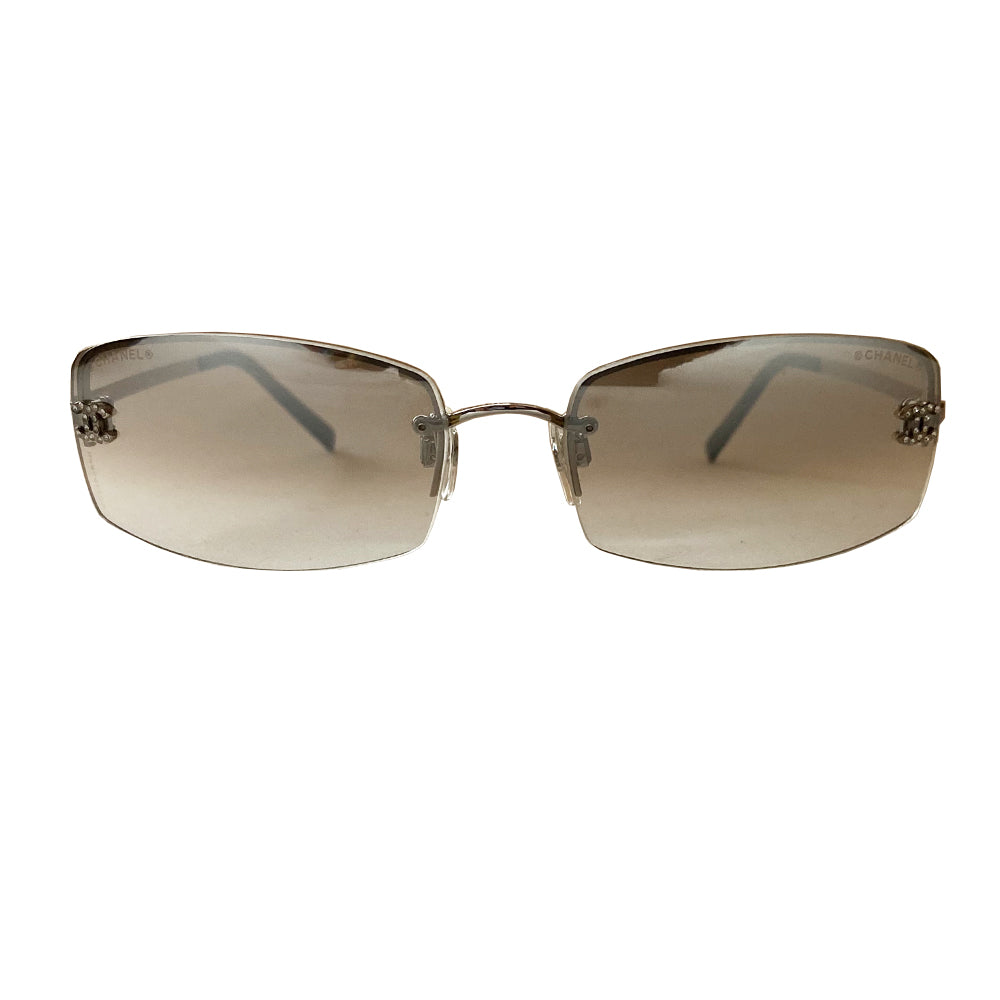 Chanel clear lens crystal CC logo sunglasses with curved rectangle shape, silver-tone metal frame on upper lens and frameless on the bottom with grey to clear lenses, interlocking crystal CC logo at each lens, Chanel engraved nose pad.  Style: 4093-B Excellent condition, with no scratch on lenses. Made in Italy 