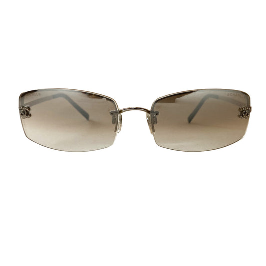 Chanel clear lens crystal CC logo sunglasses with curved rectangle shape, silver-tone metal frame on upper lens and frameless on the bottom with grey to clear lenses, interlocking crystal CC logo at each lens, Chanel engraved nose pad.  Style: 4093-B Excellent condition, with no scratch on lenses. Made in Italy 