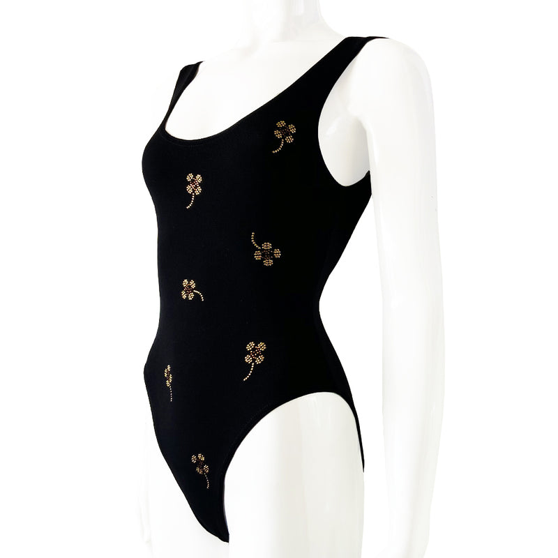 Chanel crystal appliqué embellished clover one-piece swimsuit by Karl Lagerfeld for Chanel 2001 Cruise Collection. Solid black stretch grosgrain fabric one-piece swimsuit with low back, front embellishments of tiny gold and bronze-tone appliqué crystal cc logo clovers and single logo clover in back. Size 36.  Made in France