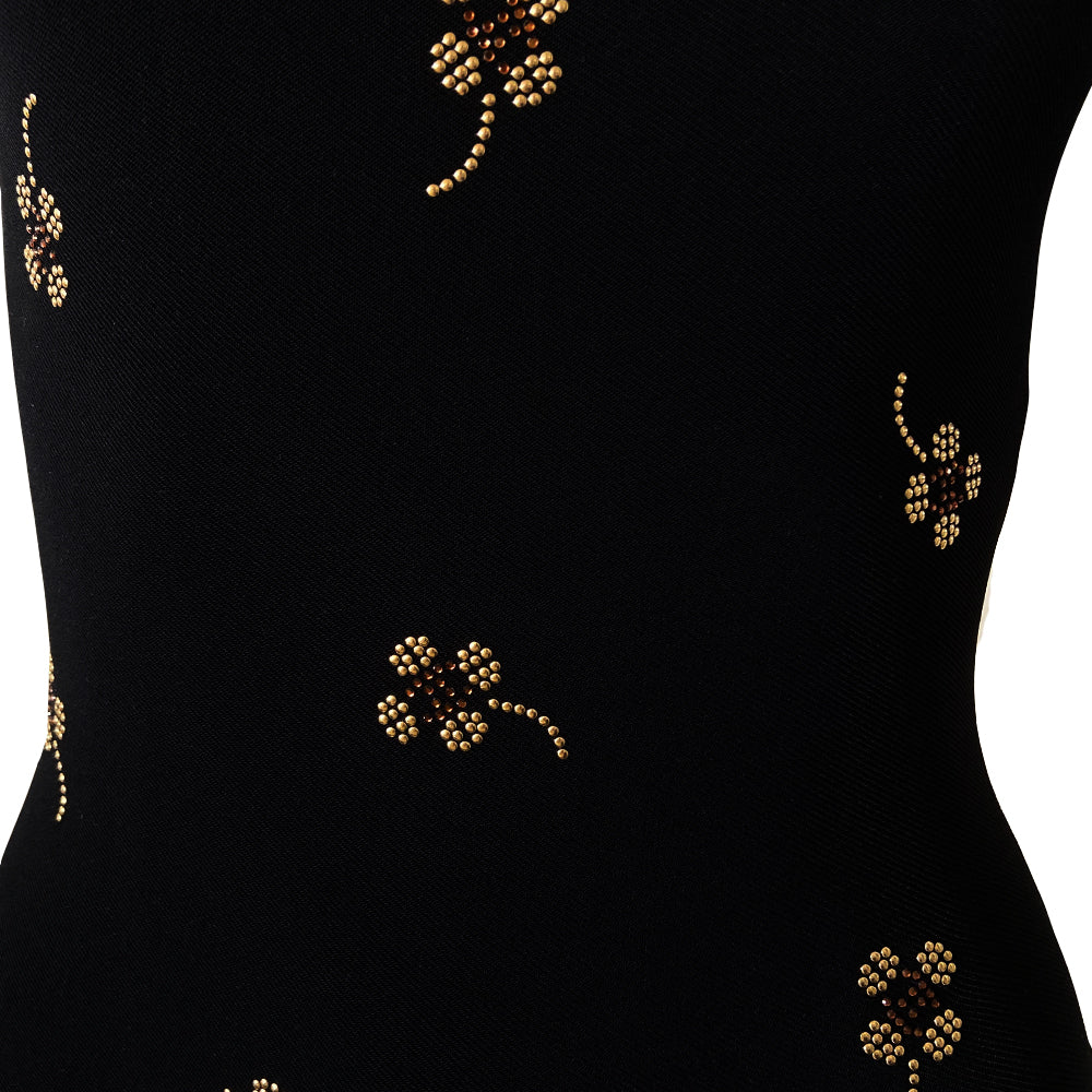Chanel crystal appliqué embellished clover one-piece swimsuit by Karl Lagerfeld for Chanel 2001 Cruise Collection. Solid black stretch grosgrain fabric one-piece swimsuit with low back, front embellishments of tiny gold and bronze-tone appliqué crystal cc logo clovers and single logo clover in back. Size 36.  Made in France