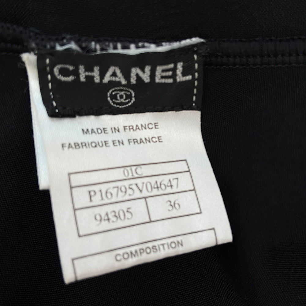 Chanel crystal appliqué embellished clover one-piece swimsuit by Karl Lagerfeld for Chanel 2001 Cruise Collection. Solid black stretch grosgrain fabric one-piece swimsuit with low back, front embellishments of tiny gold and bronze-tone appliqué crystal cc logo clovers and single logo clover in back. Size 36.  Made in France