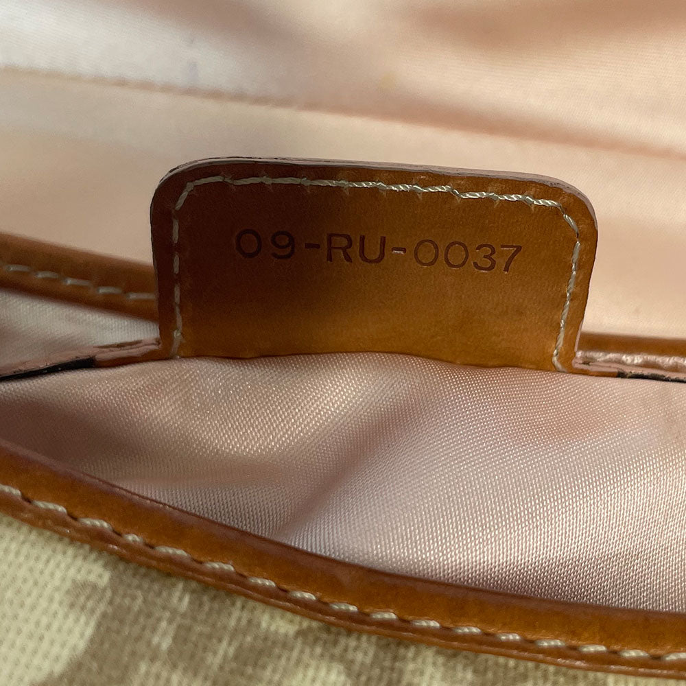 Christian Dior beige monogram coated canvas small shoulder bag by John Galliano for Dior, 2007 with brown leather piping, magnetic front flap, brown leather & pink leather bow detail with Dior logo embossed pink leather covered hanging heart. Blush rose satin lining, one zipper pocket. Pink leather woven through silver tone chain with brown leather strap. Made in Italy