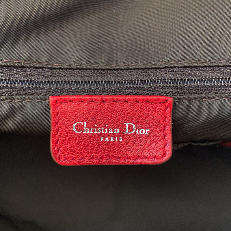 Christian Dior ad campaign Rasta Boston Bag by John Gallian for Dior. Beige and light brown Diorissimo canvas with silver-tone hardware, domed feet, 2 red leather rolled top handles, zipper pulls and end tab and red, yellow and green leather piping and tri-color leather front stripe. Made in Italy 