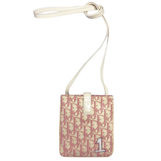 Christian Dior Girly pink monogram cross body reporter bag by John Galliano for Dior 2004 with pearl center white flowers, white piping, Swarovski crystal No 1 & Dior logo. Pink satin webbing adjustable shoulder strap with silver-tone Dior engraved sliders. Pink textile interior, one inner pocket. Made in Italy