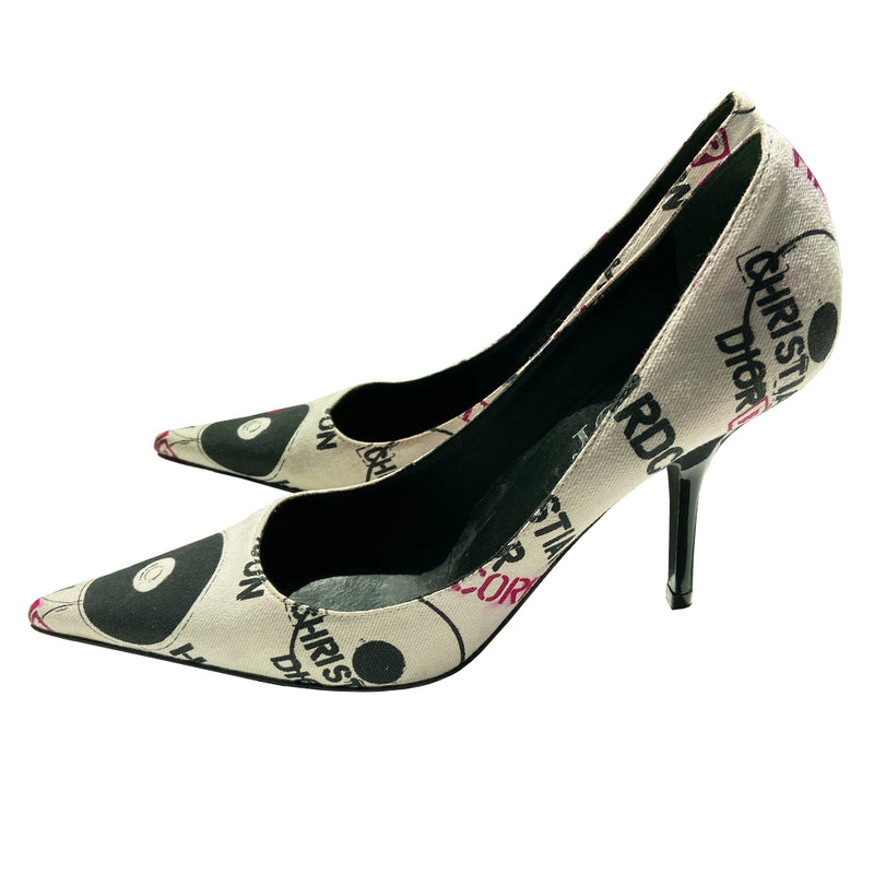 Christian Dior Hardcore Dior canvas pumps by John Galliano for Dior, Circa 2003. Closed toe heeled pump with Hardcore Dior all over print in red and black on white canvas. High gloss black heel with black leather soles and leather Dior logo insoles  Size: IT 38.5  Made in Italy 