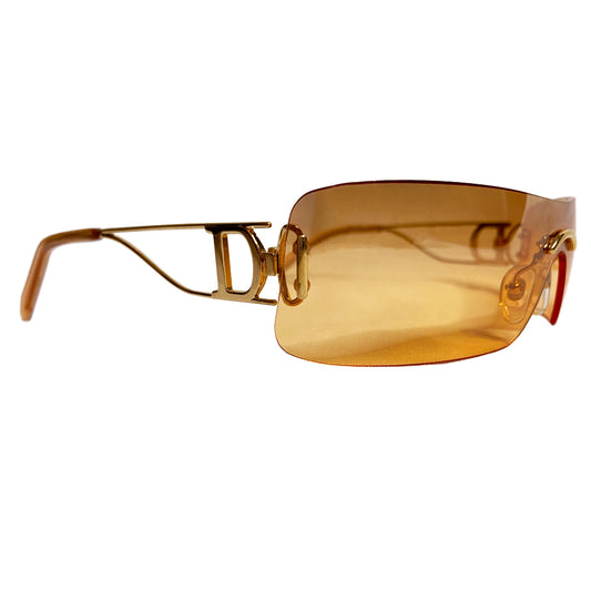 Christian Dior Miss Diorella sunglasses, rectangular slightly mirrored rimless shield lens with gold-tone metal split arms and logo D at temple, adjustable nose pieces 100% UV protection. Sunset orange with gold-tone metal frames Style: Missdiorella/N 34NSP 125 Case and card included. Made in Austria 