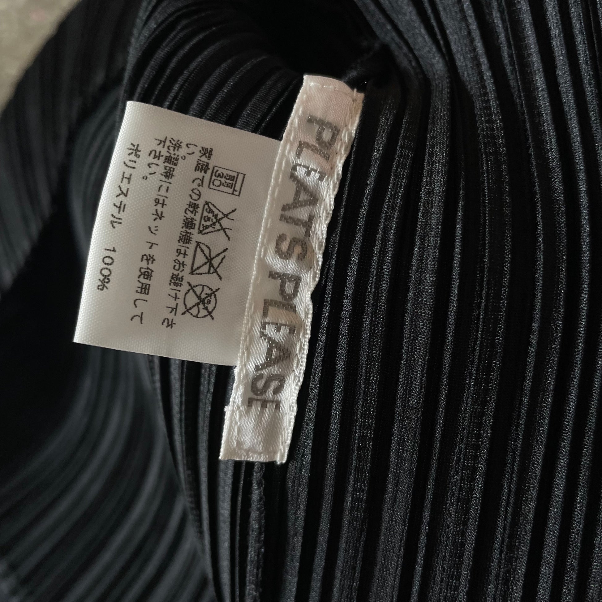 Issey Miyake Pleats Please black finely pleated short sleeve top circa 1990's with single top button with keyhole opening. Made in Japan 