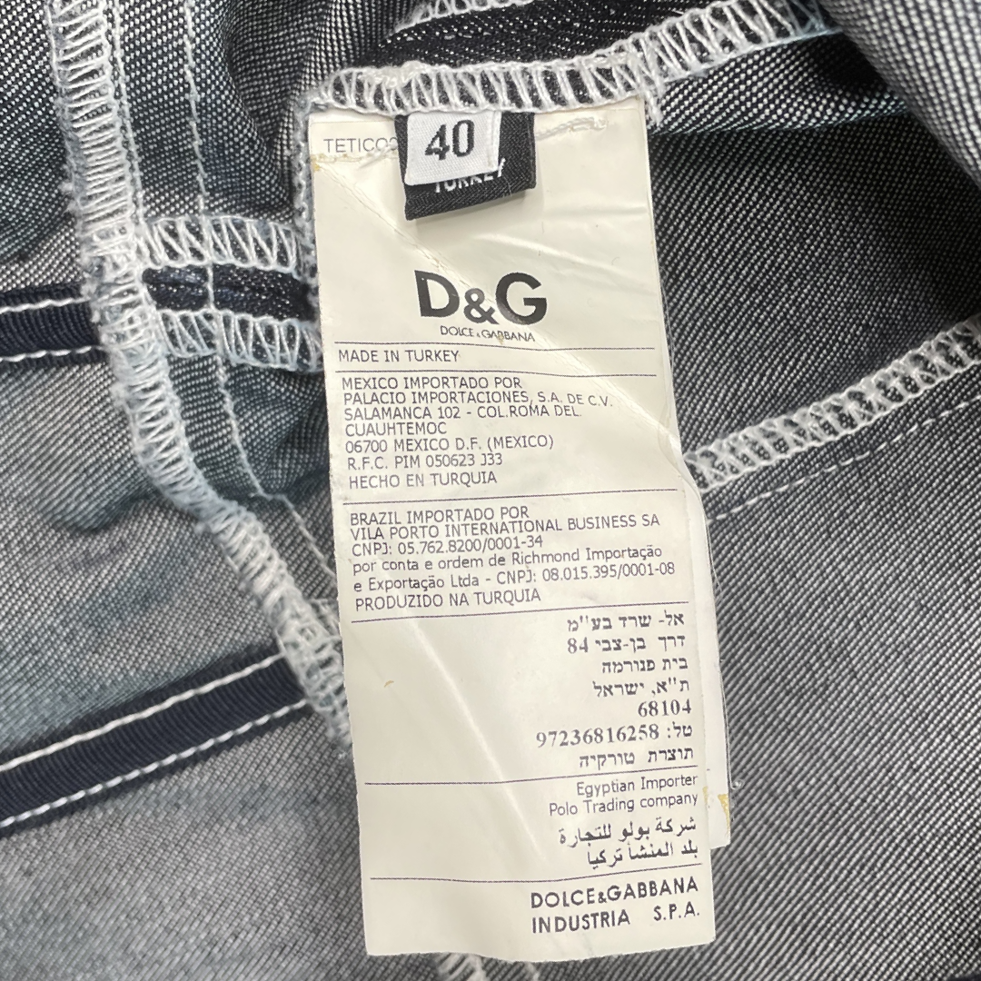 Dolce & Gabbana dark denim strapless mid-length corset dress with double criss crossed golden brown leather front lacing on bodice, white contest stitching, removable elastic straps. Exposed D&G stamped silver-tone back zipper 