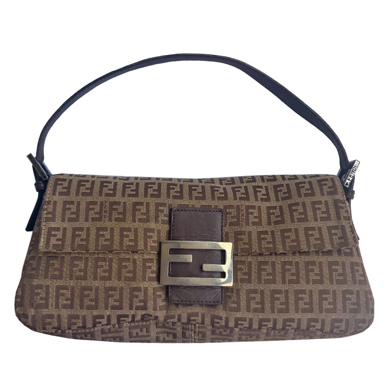 Fendi FF Zucca tan and brown canvas fabric baguette with adjustable chocolate color leather strap and accent, silver-tone Fendi engraved metal hardware and front logo. Front flap with single magnetic closure, canvas interior with Fendi engraved metal plate attached to single slip pocket. Made in Italy 