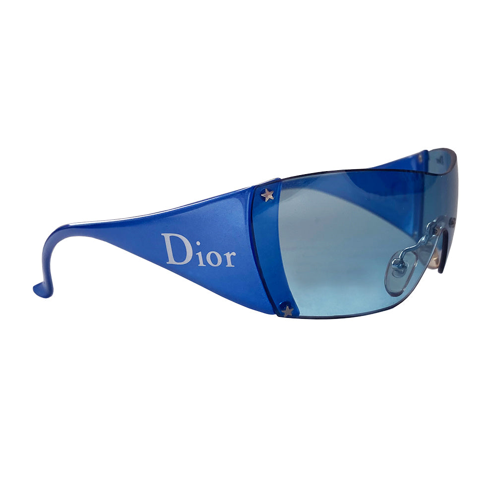 Christian Dior blue wrap around frameless Baby Dior children’s sized shield sunglasses  from John Galliano for Dior with attached non-folding arms Dior logo at temple and left side on lens with star studs at lens edges and nose piece. Case and dust cloth included. 