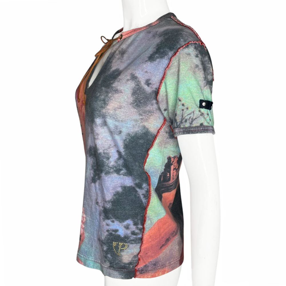 Short sleeve all-over printed tee featuring a man and woman in loving embrace Open neck tied with faux suede ties through silver-tone grommets, exposed seams at shoulders and side seams. Studded VP Logo on front lower left and crystal embellished velvet patch at shoulder. 