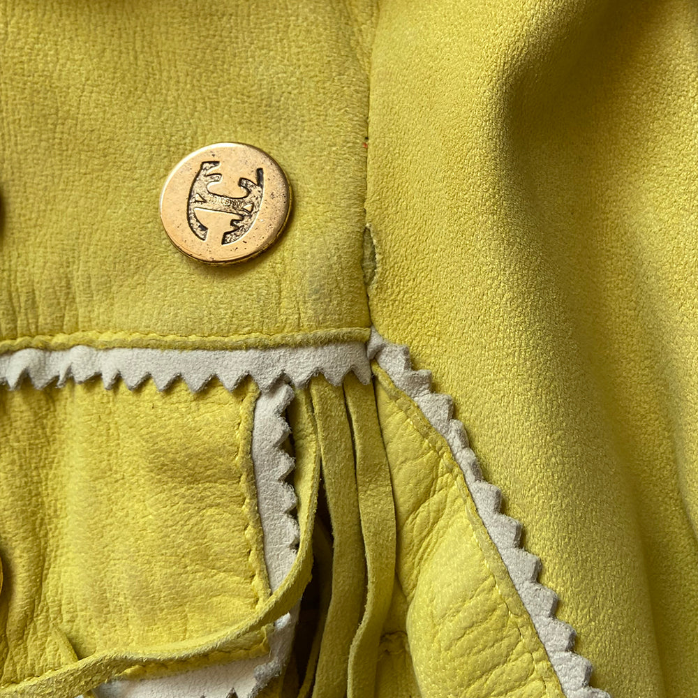 Just Cavalli Acid Yellow Fringe Leather Jacket Circa 2006 in excellent condition. Oversized and small gold-tone logo medallions decoration with whip stitching, fringe and grommets in soft sueded leather. A band of embroidery decorates the bottom hem. 