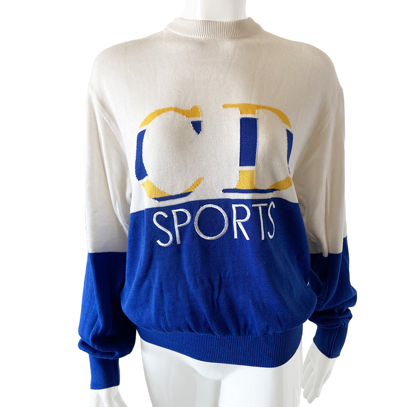 Christian Dior CD Sports Sweater circa 1980’s 1990’s crew neck color block sweater with intarsia knit CD Logo and embellished with embroidered letters with ribbing at neck, sleeve and bottom hem in blue/white with yellow Size Large.  Good condition, consistent with age. 