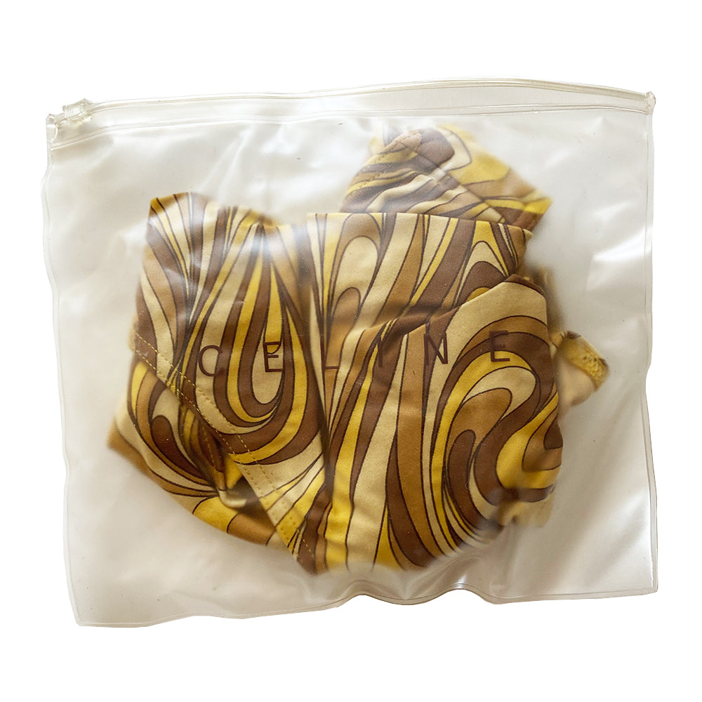 Celine psychedelic swimsuit with all over retro swirl design top and mid rise bottoms with a feature bronze-tone rectangular logo engraved plate that attaches the top to the bottom. Non adjustable halter style top with clip back logo closure, fully lined. Color: gold, brown, tan. Made in France 