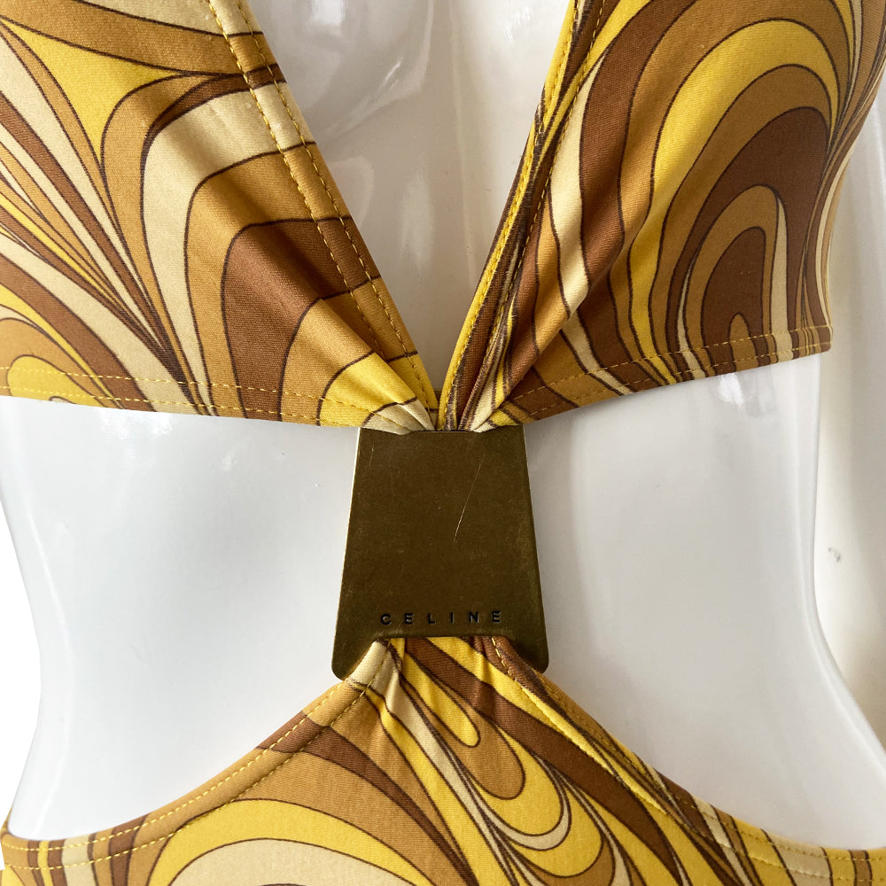 Celine psychedelic swimsuit with all over retro swirl design top and mid rise bottoms with a feature bronze-tone rectangular logo engraved plate that attaches the top to the bottom. Non adjustable halter style top with clip back logo closure, fully lined. Color: gold, brown, tan. Made in France 