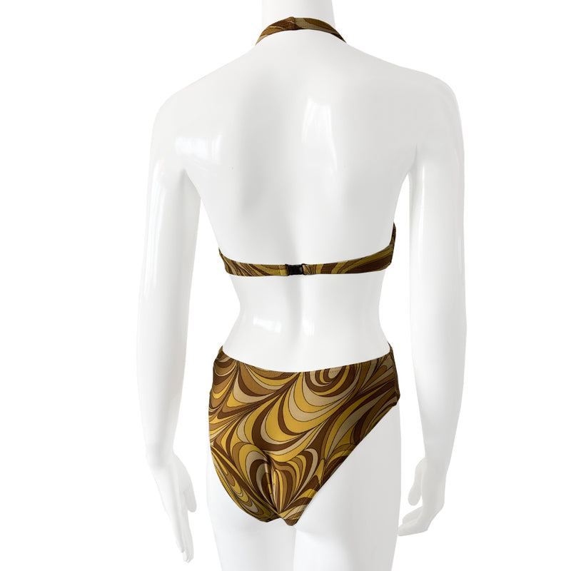 Celine psychedelic swimsuit with all over retro swirl design top and mid rise bottoms with a feature bronze-tone rectangular logo engraved plate that attaches the top to the bottom. Non adjustable halter style top with clip back logo closure, fully lined. Color: gold, brown, tan. Made in France 