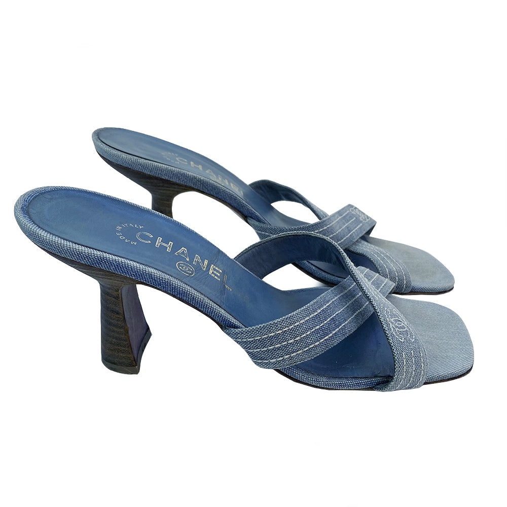 Chanel Blue Denim Criss Cross Slide Heels slip on style with criss cross denim and open toe with white accent stitching and CC logo, tan leather soles and wood heels Very good condition overall.  Material: Denim upper, leather inner sole, leather bottom sole Color: light blue Size: 39 Made in Italy 