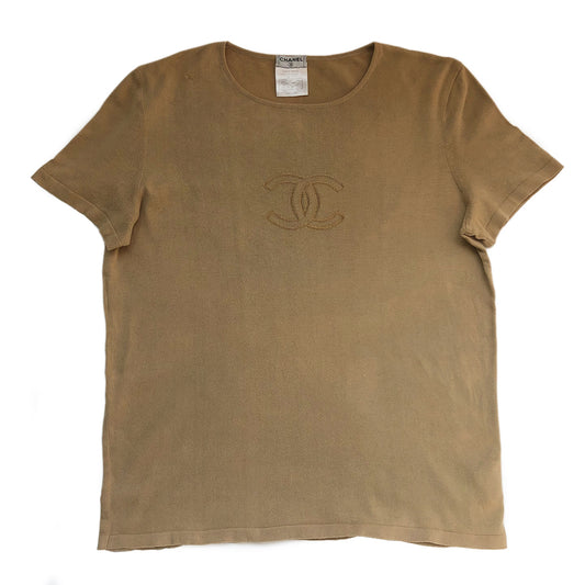 Chanel Tan color Short Sleeved Knit Top Interlocking with CC logo woven into fabric in front. Small repair to right shoulder, visually minimal while wearing. Short sleeves with round neck in fine rib knit of 100% cotton. Color: Tan Size: FR 44 Made in France 
