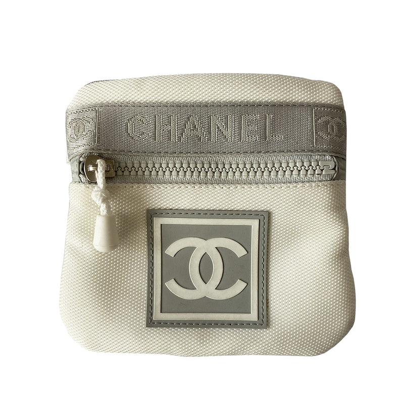 Chanel Sports Line white with light grey accent canvas arm pouch by Karl Lagerfeld for Chanel, spring 2001. CHANEL embossing and CC logo on front webbing accent strap, box CC rubber logo at center, double elastic slip on arm bands. Zip front with white zipper pull closure, light grey textile interior and Chanel rubber tag. Made in Italy 