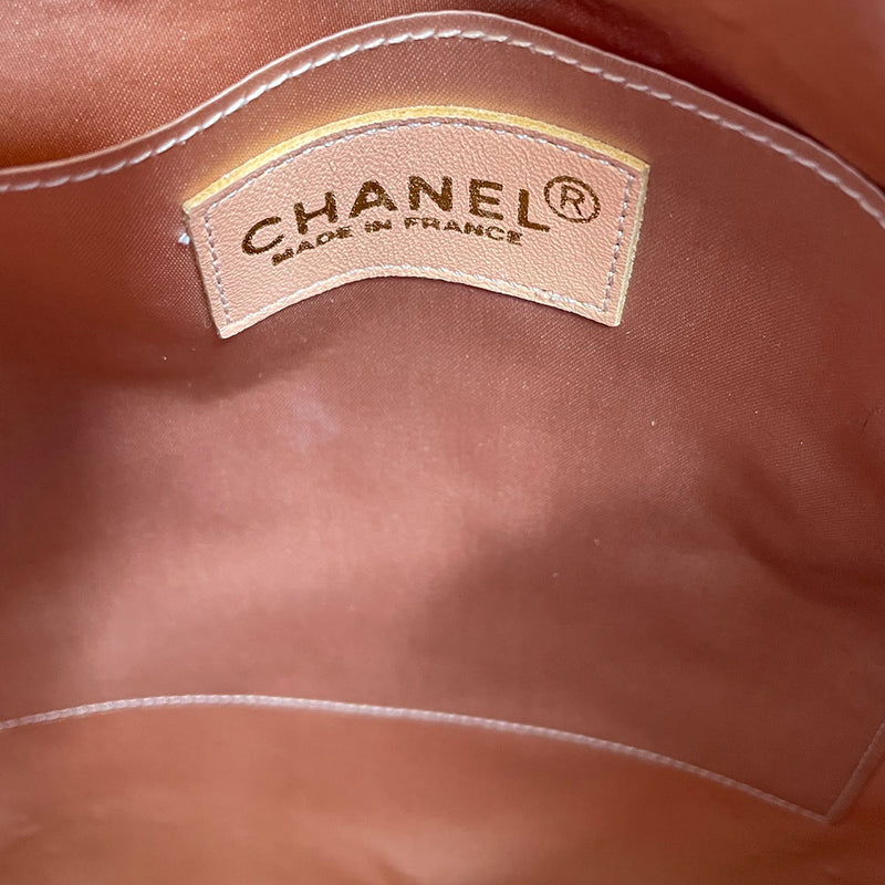 Chanel pink quilted satin and tan suede soft backpack by Karl Lagerfeld for Chanel 2001 with suede drawstring closure, silver-tone Chanel stamped tips and suede straps. Embedded faux pearls spell-out CHANEL embellishment on exterior suede satin interior with single slip pocket. Folds down flat. Made in France 