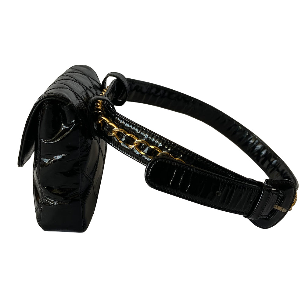 Chanel black quilted patent leather flap belt bag by Karl Lagerfeld for Chanel with gold tone turnlock closure and woven gold chain attached to adjustable belt. Black leather interior with single zip pocket. Indicated belt size: 70cm / 28 Included: Original boutique sticker and guarantee cards. Made in Italy 