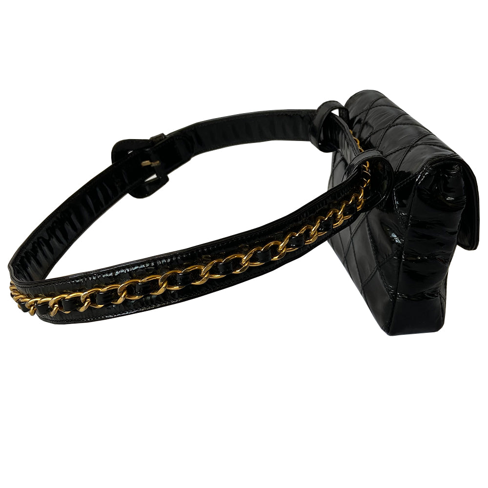 Chanel black quilted patent leather flap belt bag by Karl Lagerfeld for Chanel with gold tone turnlock closure and woven gold chain attached to adjustable belt. Black leather interior with single zip pocket. Indicated belt size: 70cm / 28 Included: Original boutique sticker and guarantee cards. Made in Italy 