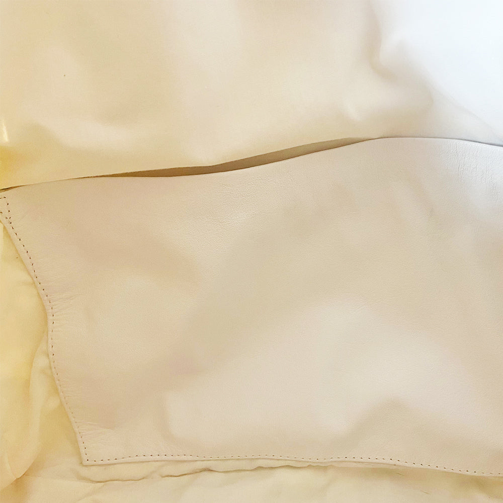 Chanel Logo white canvas quilted bowler by Karl Lagerfeld for Chanel 2001 with rolled leather handles, leather piping and grey leather, front CHANEL logo letters. Silver-tone top zip closure with CC logo grey rubber zipper pulls, Chanel logo rubber protective feet. White textile lining, one open leather pocket. Made in Italy