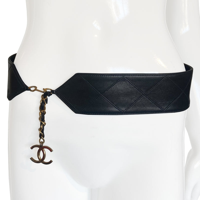Chanel circa 1980 black lamb leather diamond quilted wide belt with attached interwoven gold plated chain with leather hanging CC gold-tone logo charm, hook closure. Made in Italy