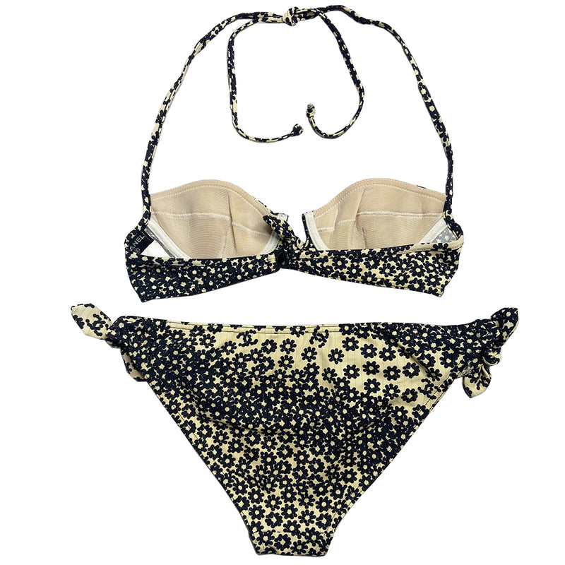 Chanel black and white floral bikini Karl Lagerfeld for Chanel, 2003 with wide ribbed top and low rise bottoms feature clusters of tiny black flowers and CC logo print throughout. Underwire padded bra with clasp back closure, ties behind the neck, front tie detail,  bottoms feature side ties. Made in France