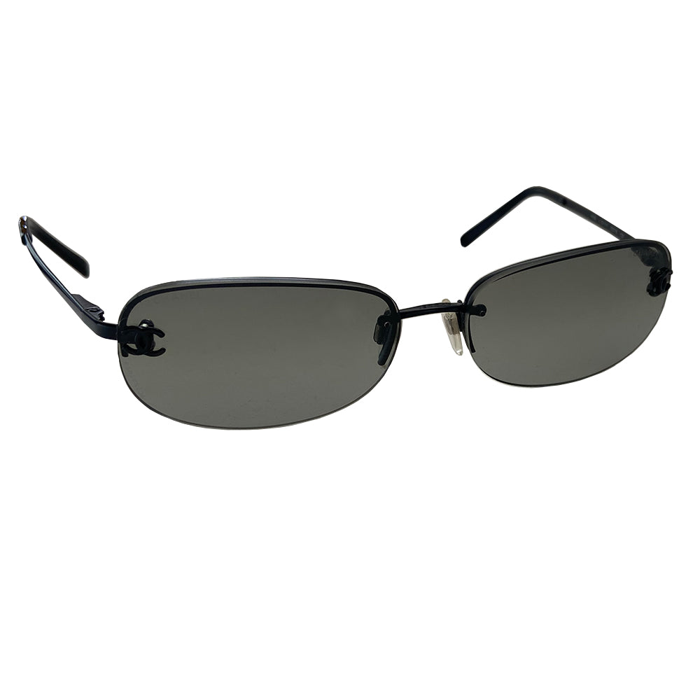 Chanel Black CC logo rectangle shape sunglasses with flat black metal frame along upper and frameless on the bottom with charcoal tinted lenses, black CC logo at each lens, Chanel engraved nose pad. Style: 4099 c.101/11 Made in Italy.