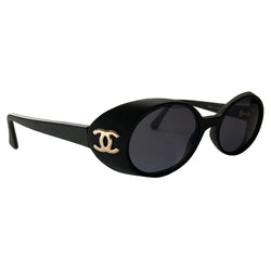 Chanel 1990’s oval goggle sunglasses by Karl Lagerfeld for Chanel. Oval goggle style acetate frames with dark charcoal lenses, interlocking CC gold logos at temple Frame Color: Flat black Style: 05976 Case included Condition: Excellent with no scratches on lens or frame, case in good condition Made in Italy